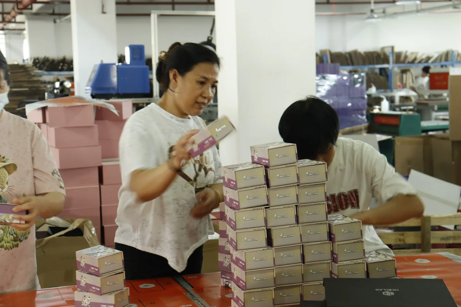 Box assembly — tuck boxes formed and loaded